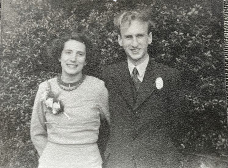 A young couple photographed together outdoors