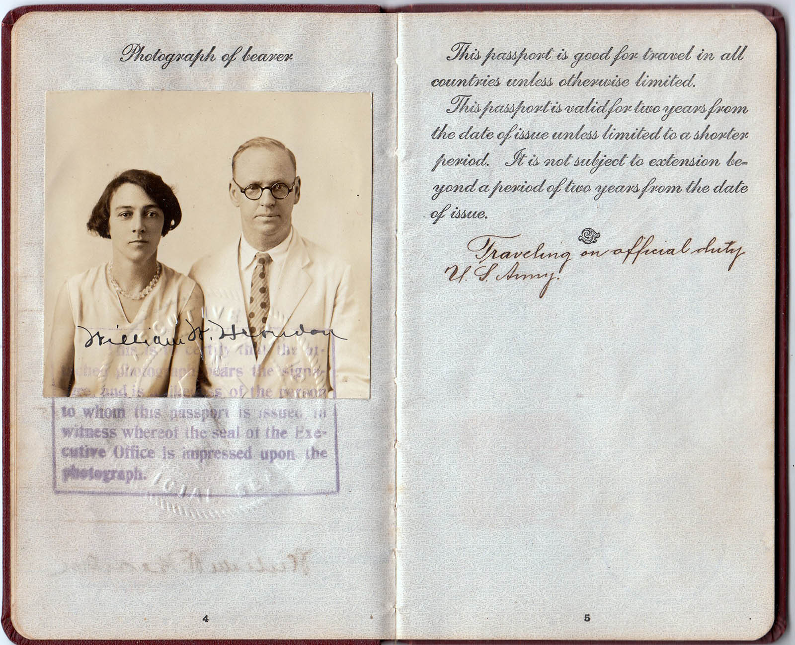 Open historic passport containing a married couple's photograph